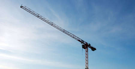 Building Crane Over Blue Slightly Cloudy Skyの写真素材