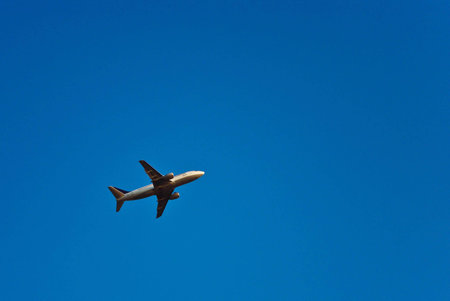 Airplane takes off in the blue cloudless sky