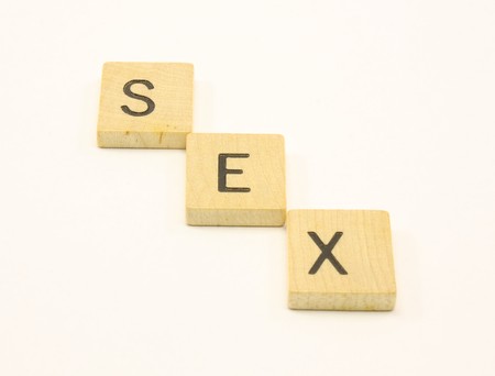 Wooden tiles spell out the word Sex diagonally.の写真素材