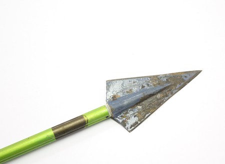 Old vintage arrow and broadhead on white background.の写真素材