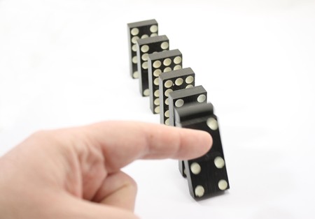Dominoes have been pushed over and are falling.の写真素材