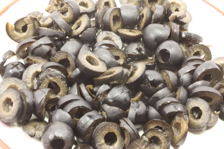 A plate of sliced black olives, macro close up.の写真素材