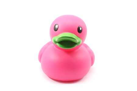 Dark pink bathtub duck toy with green bill on white backgroundの写真素材