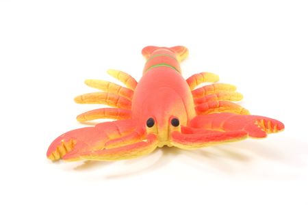 Toy lobster facing you on a white background.の写真素材