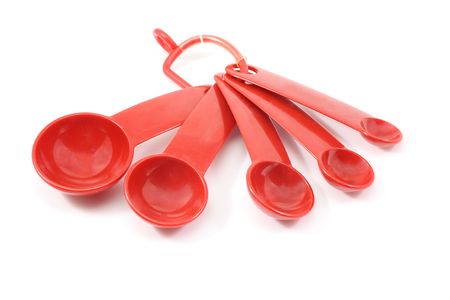 Red measurement spoons on a white background.の写真素材