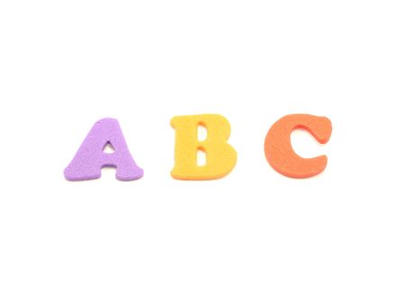 Foam letters spell out a colorful ABC on a whtie background.の写真素材