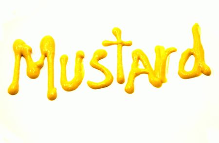 Mustard Written in Yellow Mustard on a white background.の写真素材