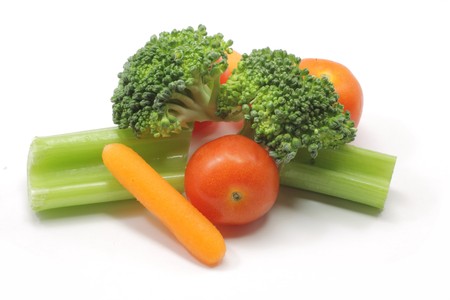 A healthy snack of carrots, celery, broccoli, and tomatoes.の写真素材