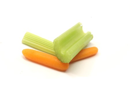Celery and carrots on a white background.の写真素材