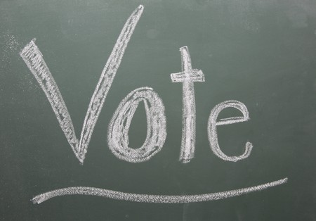 Vote written on blackboard in white chalk and underlined.の写真素材