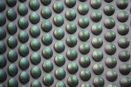 A pattern of circles on a lighted neon sign making an interesting background.の写真素材