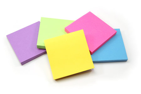 A colorful array of sticky note pads including purple, pink, green, yellow, and blue.