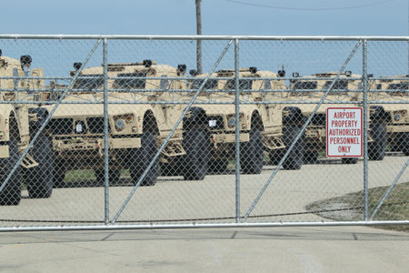 OSHKOSH, WI - APRIL 3: A row of Oshkosh Corp military Humvees sit in a row behind a fence at Wittman Airport ready to be deployed to Afghanistan and Iraq on April 3, 2010 in Oshkosh, Wisconsin. のeditorial素材
