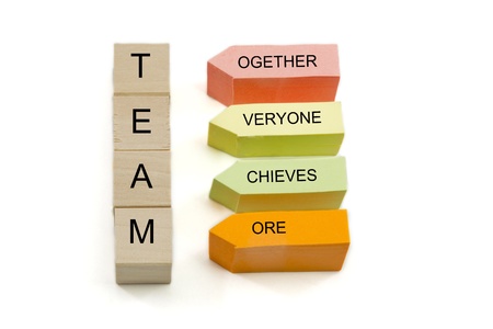 TEAM, together everyone achieves more spelled out on wooden blocks and colorful sticky notes.の写真素材