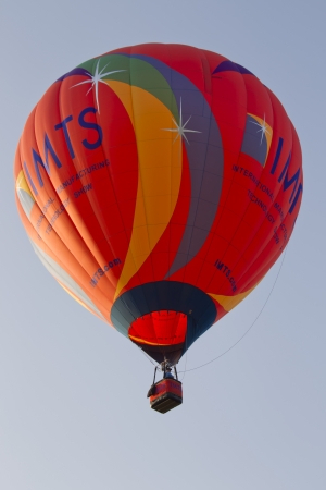SEYMOUR, WI - AUGUST 3: A big orange IMTS hot air balloon in the sky at the Balloon Rally at the Annual Hamburger Festival on August 3, 2012 in Seymour, Wisconsin.のeditorial素材