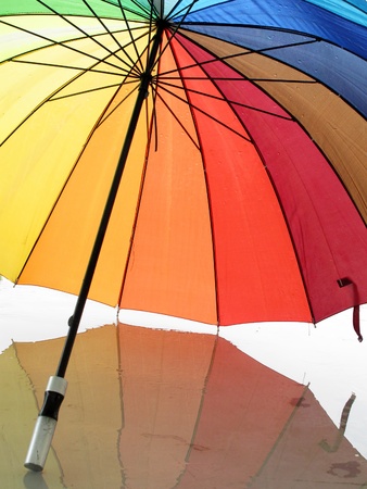 Opened multicolored umbrella with reflection                          の写真素材