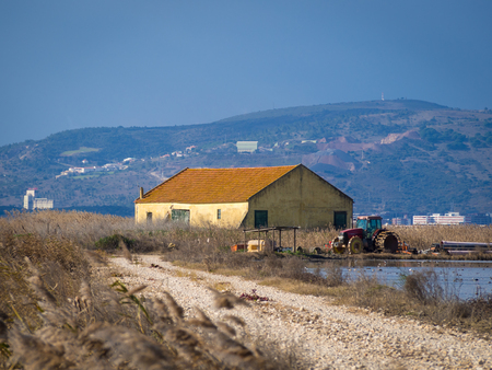 Farm house under cloudy blue skyの写真素材