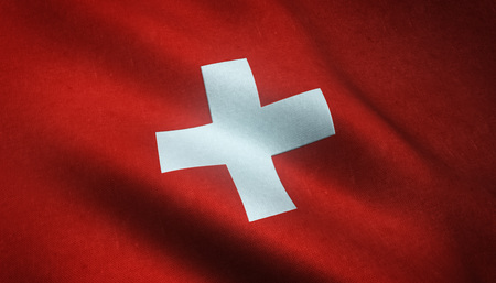 Realistic flag of Switzerland waving with highly detailed fabric texture.の写真素材