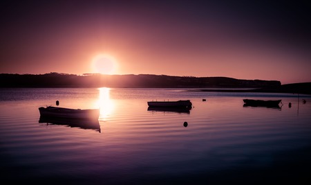Fishing boats and sunset at the riverの写真素材