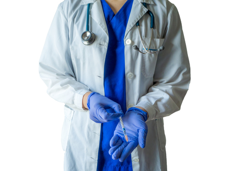 Unknown female doctor in medical uniform with mask holding a syringe ready for injection. Caucasian female model isolated over white background.の写真素材