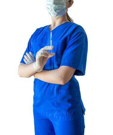 Unknown young female doctor in blue medical uniform holding a syringe ready for injection. Caucasian female model isolated over white background.の写真素材