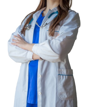 Portrait of an unknown doctor in medical uniform with crossed hands. Caucasian female model isolated over white background.の写真素材