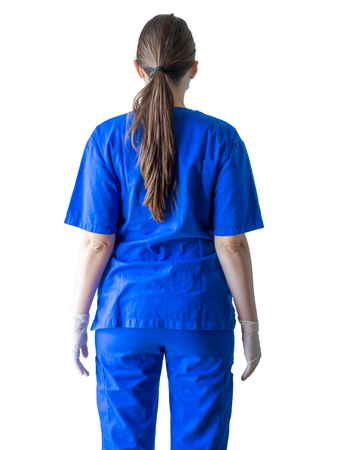 Portrait of an unknown young doctor in blue medical uniform with hands in sterilized surgical gloves. Caucasian female model isolated over white background.の写真素材