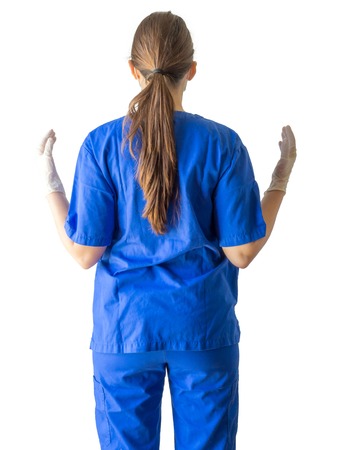 Portrait of an unknown young doctor in blue medical uniform with hands in sterilized surgical gloves. Caucasian female model isolated over white background.の写真素材