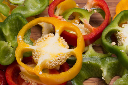 colorful pieces of pepper on plank