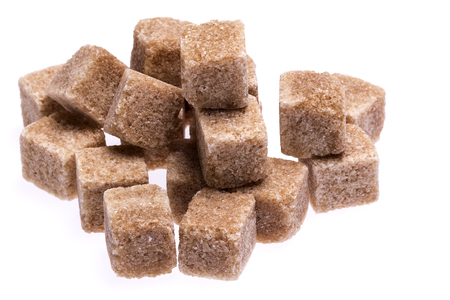 brown cane sugar cubes isolated on white background, close upの写真素材