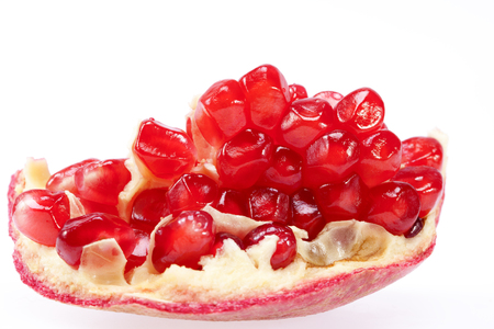 piece of fruit of red pomegranate isolated on white background, close up.の写真素材