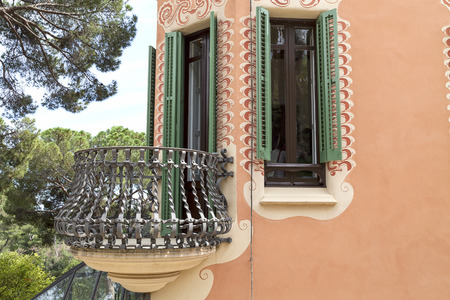 BARCELONA , SPAIN - MAY 13, 2016 : Facade with metal balcony on Gaudi House Museum. Building  located near the Park Guell  in Barcelona was the residence of Antoni Gaudi for almost 20 years, from 1906 to 1925.の写真素材