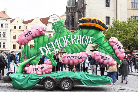 PRAGUE, CZECH REPUBLIC - MAJ 01, 2017 : Celebration of the Labour Day May 1 at Old Town Square in Prague - banner illustrating democracy as a leaf bitten by caterpillars with names:Putin, Kaczynski, Orban, Babis, Trump, Fico.のeditorial素材