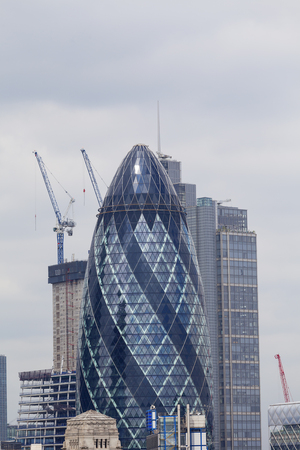 LONDON, UNITED KINGDOM - JUNE 22, 2017:  London's primary financial district, the City of London, commercial skyscraper Gherkin, Millennium Tower. It was opened in April 2004 with 41 storeys, it is 180 metres tall.のeditorial素材