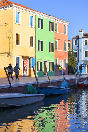 VENICE-ITALY, SEPTEMBER  21, 2017: Colorful small, brightly painted houses on the island of Burano, reflection in the water. Burano is an island in the Venetian Lagoon, situated 7 kilometers  from Veniceのeditorial素材