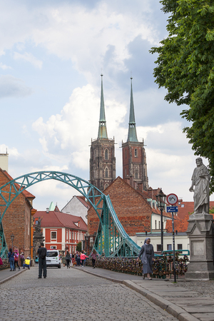 WROCLAW - POLAND, JUNE 12, 2017: Wroclaw Cathedral (Cathedral of St. John the Baptist), gothic style 13th century church and Tumski Bridge on Ostrow Tumski Island. It is the oldest part of the city of Wroclawのeditorial素材