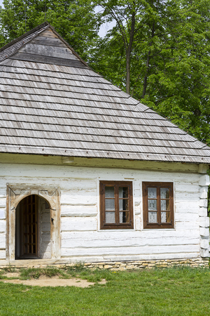 TOKARNIA, POLAND - MAY 2, 2018: Old traditional polish wooden house in open-air museum, Museum of the Kielce Village ( Muzeum Wsi Kieleckiej),  rural landscapeのeditorial素材