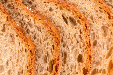 Background of slices of rye wheat bread, bread crust, close up