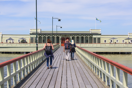 MALMO, SWEDEN - JUNE 24, 2019: Ribersborgs open-air bath, wooden pier in the Baltic Sea with walking peopleのeditorial素材