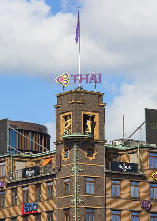 COPENHAGEN, DENMARK - JUNE 22, 2019: Movable famous barometer on the roof of the building, girl with a bicycle and boy with umbrellaのeditorial素材