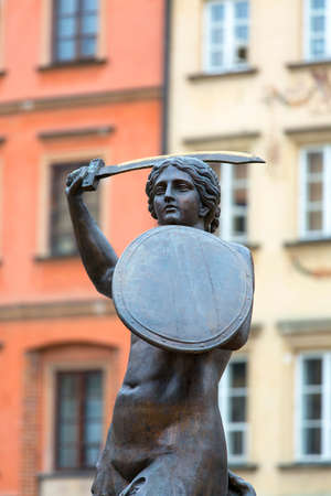WARSAW, POLAND -OCTOBER 17, 2019: Mermaid statue at Old Town Market Place, decorative facade of tenement houses. The square was destroyed during World War IIのeditorial素材