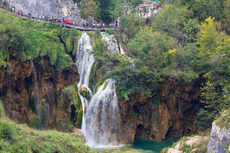 Plitvice Lakes, Croatia - September 2, 2019:  Plitvice Lakes National Park, a miracle of nature, tourists walking on the wooden bridgeのeditorial素材