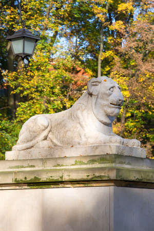Warsaw, Poland - October 19, 2019: Classical theater isle stage, amphitheater in Warsaw Royal Baths Park, Lazienki Warszawskie, stone statue of lionのeditorial素材