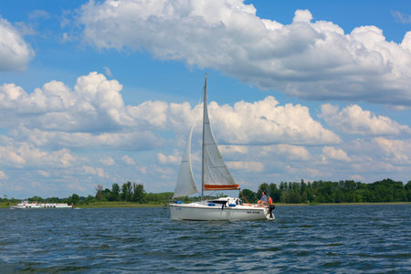 Masuria, Poland - June 24, 2020 : Lake in Polish Masuria, sailing yachts on a sunny day. Picturesque...