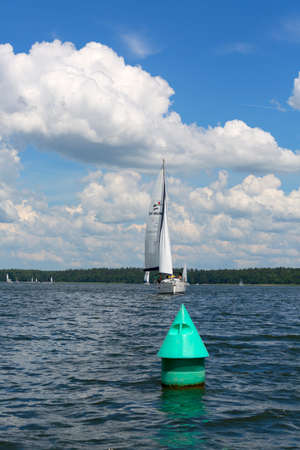 Masuria, Poland - June 24, 2020: Lake in Polish Masuria, sailing yachts on a sunny day. Picturesque cloudy skyのeditorial素材