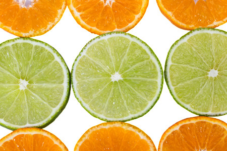 Fruit slices of mandarin and green lime isolated on white background, close up