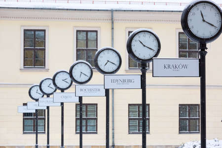 Krakow, Poland - January 17, 2021: Snowy winter in Krakow, Holy Ghost Square, clocks showing the current time in different cities around the worldのeditorial素材