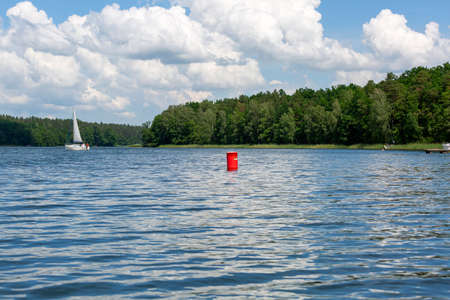 Masuria, Poland - June 24, 2020: Lake in Polish Masuria, sailing yachts on a sunny day. Picturesque skyの写真素材