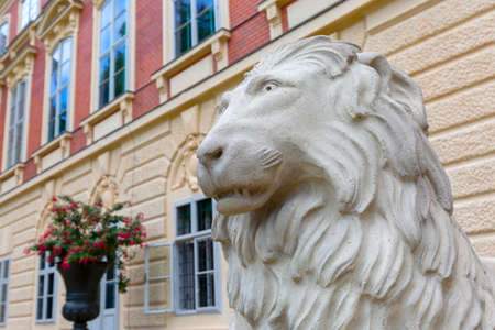 Lancut, Poland - August 26, 2020: Statue of stone lion in front of 16th century baroque Lancut Castle, former Polish magnate residence.のeditorial素材