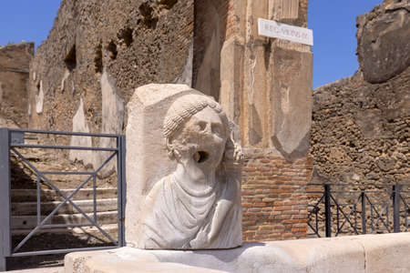 Ruins of an ancient city destroyed by the eruption of the volcano Vesuvius in 79 AD near Naples, Pompeii, Italy. A fountain for public use on one of the streetsのeditorial素材